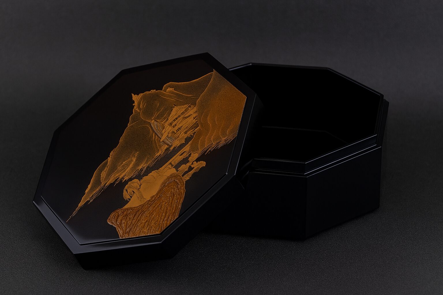 Black octagonal lacquer box with golden mountain landscape design on lid